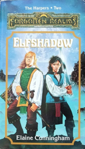 The cover of Elfshadow. A graceful black-haired woman wielding a sword stands next to a tall man who looks like a chubby football player. A giant moon fills the sky behind them.