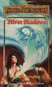 The cover of Silver Shadows. A black-haired woman with a 1980s perm is holding a sword. A spectral image of an elven woman is issuing from the sword. A big dog or wolf is watching from the corner.