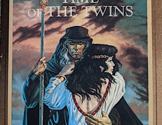 The cover of Time of the Twins. A black-robed, bronze-skinned mage stares directly at the viewer. In one hand he holds a magic staff; the other arm is around the waist of a black-haired young woman in white robes. She seems distracted, staring off to the side with a concerned expression. Behind them is a sky full of roiling clouds.